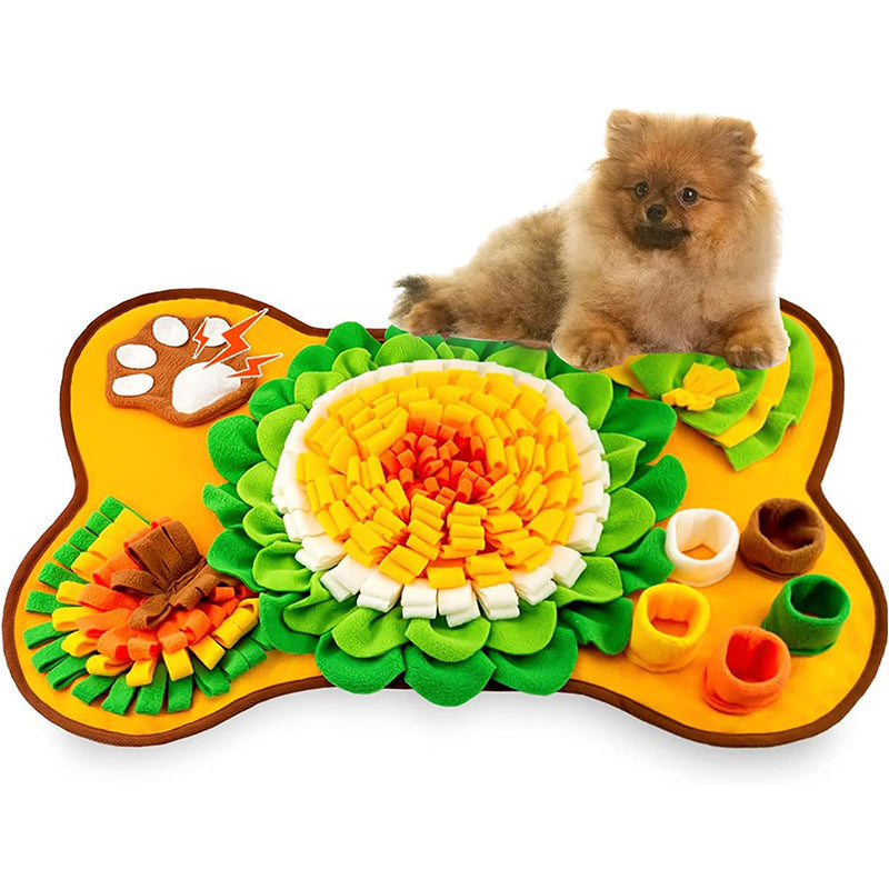 Bone-shaped orange snuffle mat for dogs with a small dog resting on it