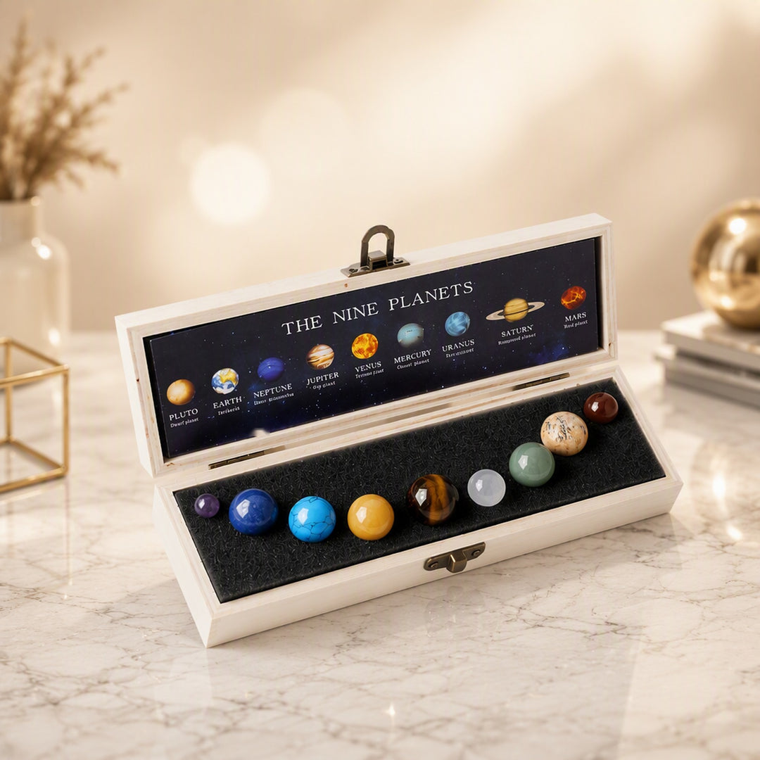 Solar system crystal collection: 9 natural gemstone planets in an open wooden display box with The Nine Planets lid
