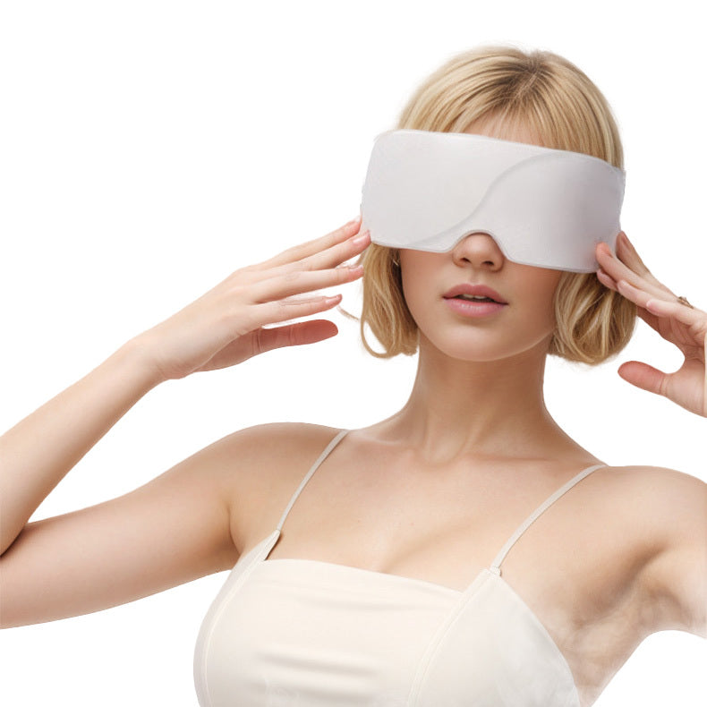 Woman wearing cordless rechargeable heated eye mask massager